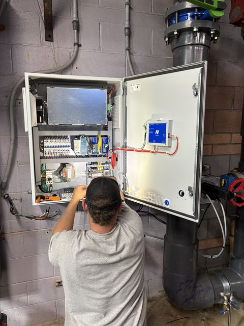 Technician maintaining a pool controller system